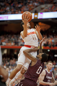 Tyler Ennis rises to the rim over Fordham guard Branden Frazier. Ennis finished with 16 points.