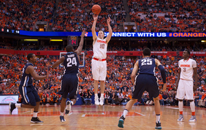 Trevor Cooney shoots over the outstretched hand of Achraf Yacoubou in Syracuse's 72-61 victory over Villanova Saturday.