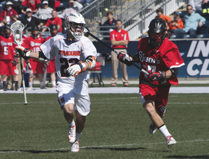 JoJo Marasco runs past St. John's defender John Bello. Marasco finished the game with four assists and a goal. 