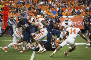 Jerome Smith busts through the Clemson defensive line. The Syracuse running back topped the 100-yard mark and rushed for a touchdown on Saturday.