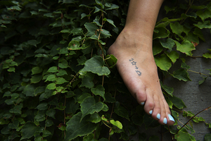 The symbols in Sydney Trager's foot tattoo can be translated to represent the quote 