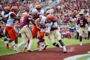 Eric Dungey tries to break through a flurry of Florida St. defensive linemen to score a touchdown.