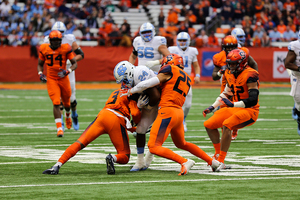 Kielan Whitner (25) helps wrap up a North Carolina ball carrier on Saturday during SU's win at the Carrier Dome.