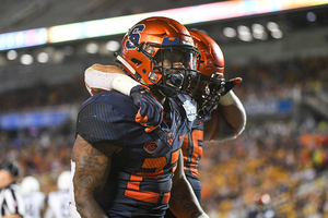 Abdul Adams (23) and Chris Elmore (36) celebrate after a touchdown.