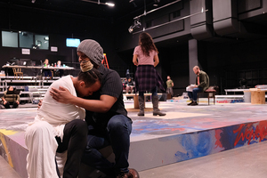 Rhyole—playing Angel Dumott Schunard (left)—and Temar Underwood—playing Tom Collins (right)—are performing an intimate scene during rehearsal for  Redhouse Arts Center’s rendition of 