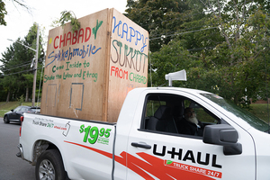 Rabbi Yaakov Rapoport drove a wooden sukkah around Syracuse on a pickup truck so they could bring the Sukkot celebration to students.