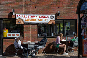 Customers sit outside of the newly-opened Collegetown Bagels location on Marshall Street. SU students said they enjoyed the location's outdoor seating and proximity to campus.
