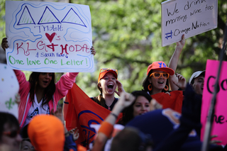 Molly Nelson (center), a junior broadcast and digital journalism major, yells in the crowd.