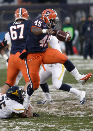 Running back Jerome Smith attempts to hurdle out of a tackle.