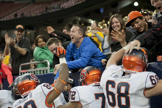 Fans and teammates mob Hunt behind the end zone following his game-winning touchdown run.