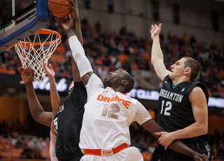 Keita attempts to lay the ball past the outstretched arms of Magnus Richards (left) and John Rinaldi. 