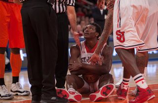 Obekpa coddles a loose ball and gets a helping hand from teammates and refs. 