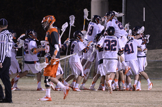 Staats walks away as Virginia celebrates a big conference win at the middle of the field. 