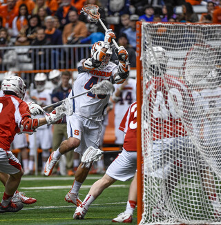 Randy Staats prepares to shoot over the shoulder of a Cornell defender after breaking through the Big Red's defense.