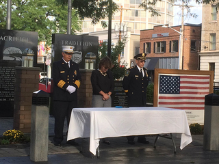 Miner and Syracuse first responders take part in the 17-minute moment of silence.