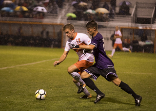 Ricks, a sophomore, jostles with an opponent. 