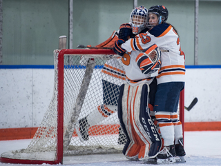 Megan Quinn hugs goalkeeper Abbey Miller.