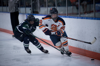 A Syracuse player works past a Mercyhurst defender along the boards. 