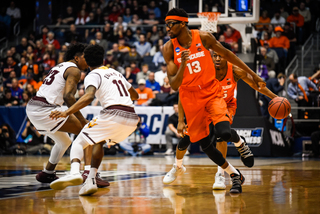 Junior Paschal Chukwu sets a screen for Battle. Chukwu, SU's 7-foot-2 center, knocked down clutch free throws late in the game to preserve SU's lead. 