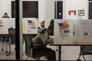 Yohely Espiritusanto, a first-year PhD student, fills out a ballot at Huntington Hall.