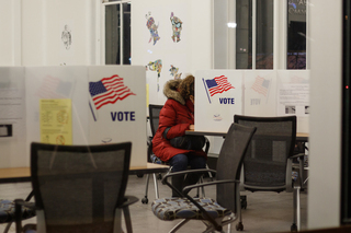 A voter fills out a ballot at Huntington Hall an hour before the polls close.