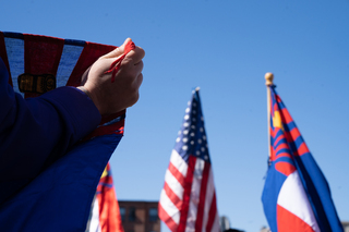 A demonstrator holds up the Karen flag.