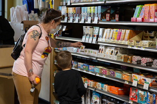 Brandi Sollars worked at the co-op about 10 years ago and brought her 3-year-old son Sebastian to the opening of the new space.