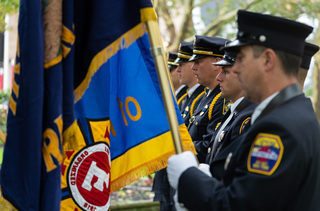 Officers from the Syracuse Police Department stand in silence and remembrance of those who lost their lives in the 9/11 terrorist attacks Sunday morning. 