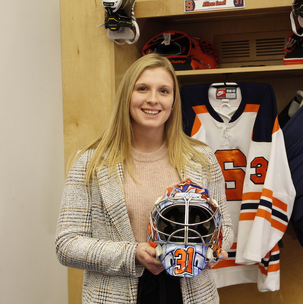 Allison Small holding her mask in the SU locker room